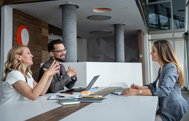 Managers interviewing candidate for job position in modern office